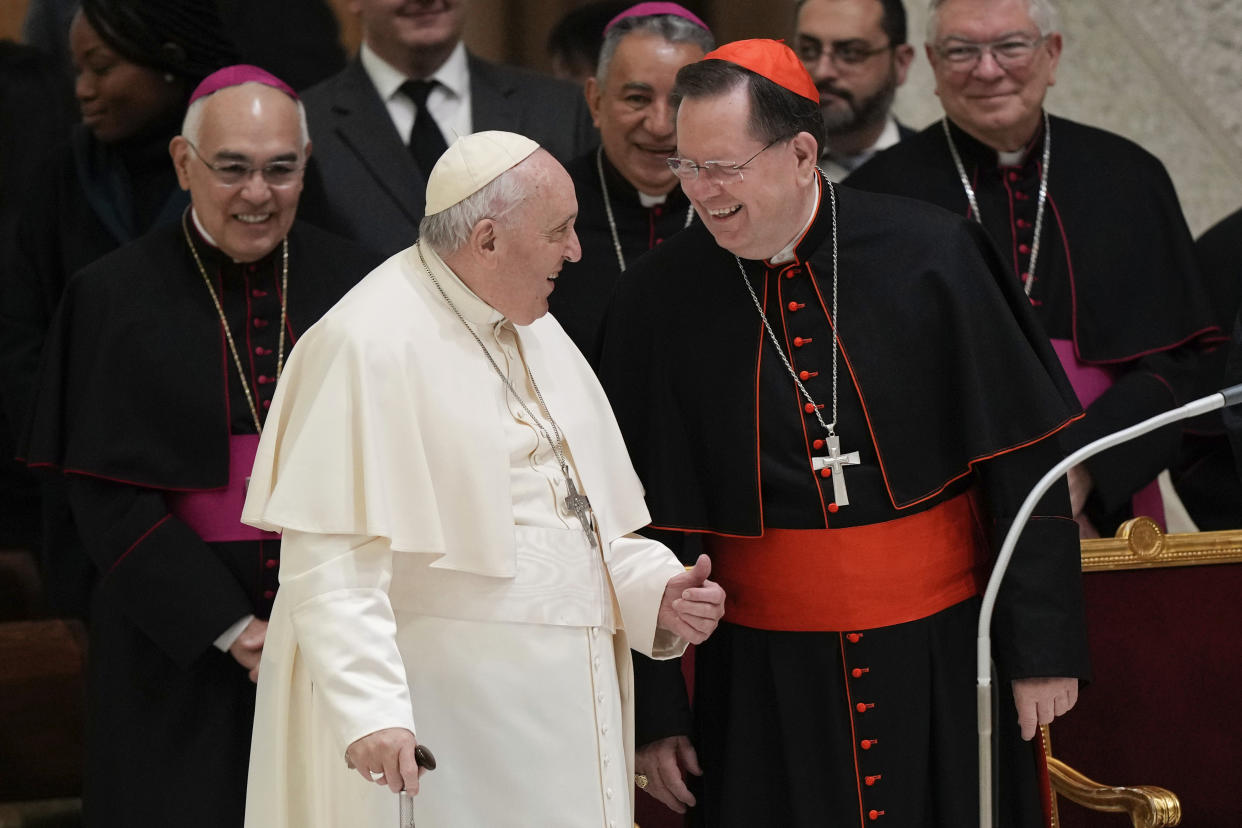 Pope Francis talks with Cardinal Gerald Lacroix as he arrives for his weekly general audience in the Pope Paul VI hall at the Vatican, Wednesday, Jan. 4, 2023. (AP Photo/Andrew Medichini)