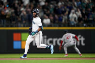 Seattle Mariners' Julio Rodríguez runs the base path after hitting a double as Boston Red Sox second baseman Enmanuel Valdez waits for the throw to the infield during the first inning of an opening day baseball game, Thursday, March 28, 2024, in Seattle. (AP Photo/Lindsey Wasson)