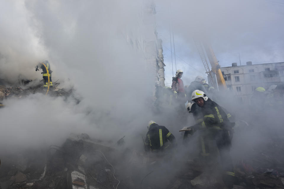 Firefighters work to extinguish a fire after a Russian attack at a residential building in Uman, central Ukraine, Friday, April 28, 2023. (AP Photo/Bernat Armangue)