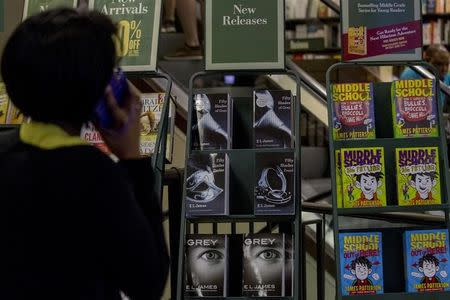 A woman looks at copies of 'Grey' in a bookstore in New York June 18, 2015. REUTERS/Brendan McDermid/File Photo