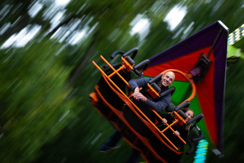 Fairgoers soar through the air on a glider as they enjoy rides along the midway of the Allegan County Fair on Monday, Sept. 12, 2022, in Allegan.