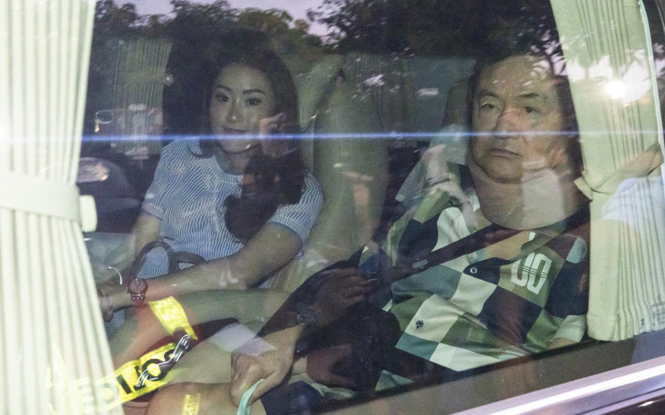 Former Thai Prime Minister Thaksin Shinawatra, right, sits in a vehicle with his daughter Paetongtarn in front of his residence after being released on parole, Sunday, Feb. 18, 2024, in Bangkok, Thailand. Thaksin was released from Police General Hospital, where for the last six months he had been serving time for corruption-related offenses. (AP Photo/Wason Wanichakorn)