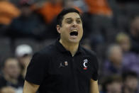 Cincinnati head coach Wes Miller talks to his team during the first half of an NCAA college basketball game against West Virginia Tuesday, March 12, 2024, in Kansas City, Mo. (AP Photo/Charlie Riedel)