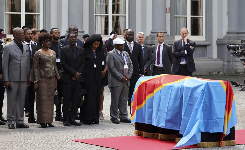 The children of Patrice Lumumba, from left, Roland, Juliana and Francois, stand next to the casket with the mortal remains of Patrice Lumumba during a ceremony at the Egmont Palace in Brussels, Monday, June 20, 2022. On Monday, more than sixty one years after his death, the mortal remains of Congo's first democratically elected prime minister Patrice Lumumba were handed over to his children during an official ceremony in Belgium. (AP Photo/Olivier Matthys)