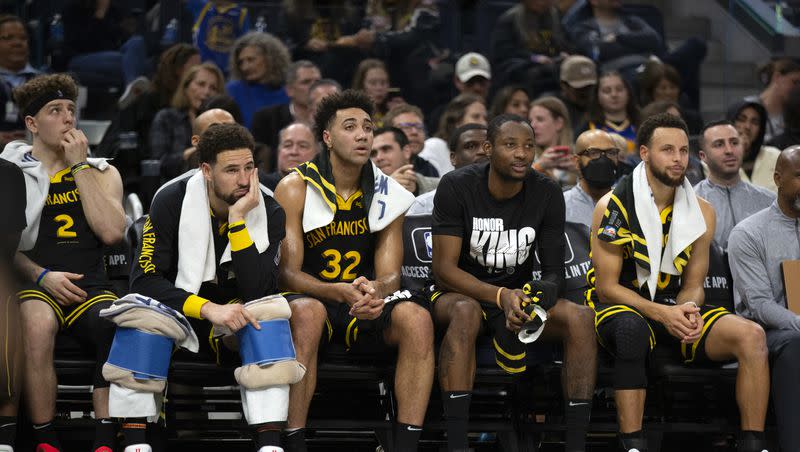 The Golden State Warriors bench watches the closing minutes of the fourth quarter of a game against the New Orleans Pelicans on Wednesday, Jan. 10, 2024, in San Francisco.