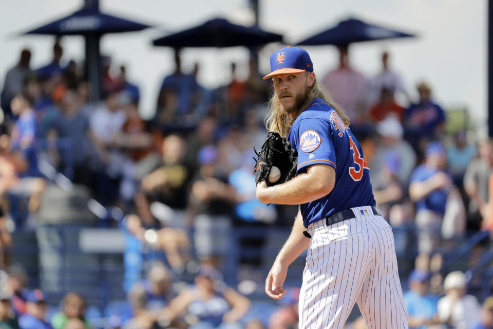 New York Mets starting pitcher Noah Syndergaard checks the runner during the first inning of an exhibition spring training baseball game against the Houston Astros Saturday, March 2, 2019, in Port St. Lucie, Fla. (AP Photo/Jeff Roberson)