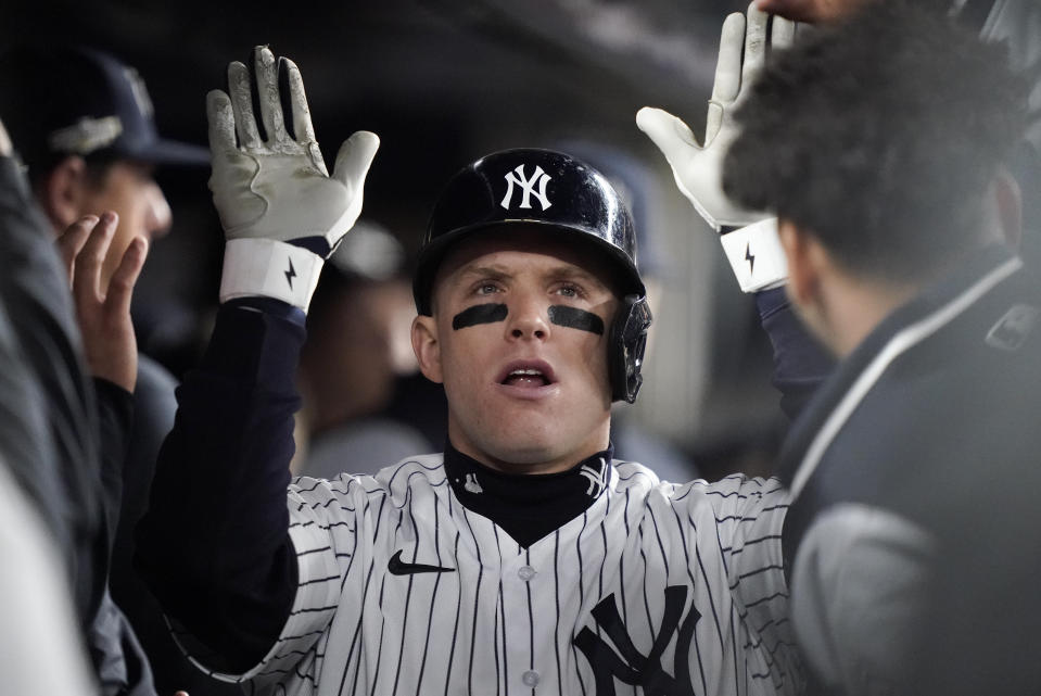 FILE - New York Yankees Harrison Bader is congratulated in the dugout after hitting a solo home run against the Houston Astros during the sixth inning of Game 4 of an American League Championship baseball series, Sunday, Oct. 23, 2022, in New York. Bader was activated from the injured list by the New York Yankees, and the speedy center fielder could make his season debut Tuesday night, May 2, against the Cleveland Guardians. Diminished by injuries, the slumping Yankees hope Bader can spark their offense a bit. (AP Photo/John Minchillo, File)