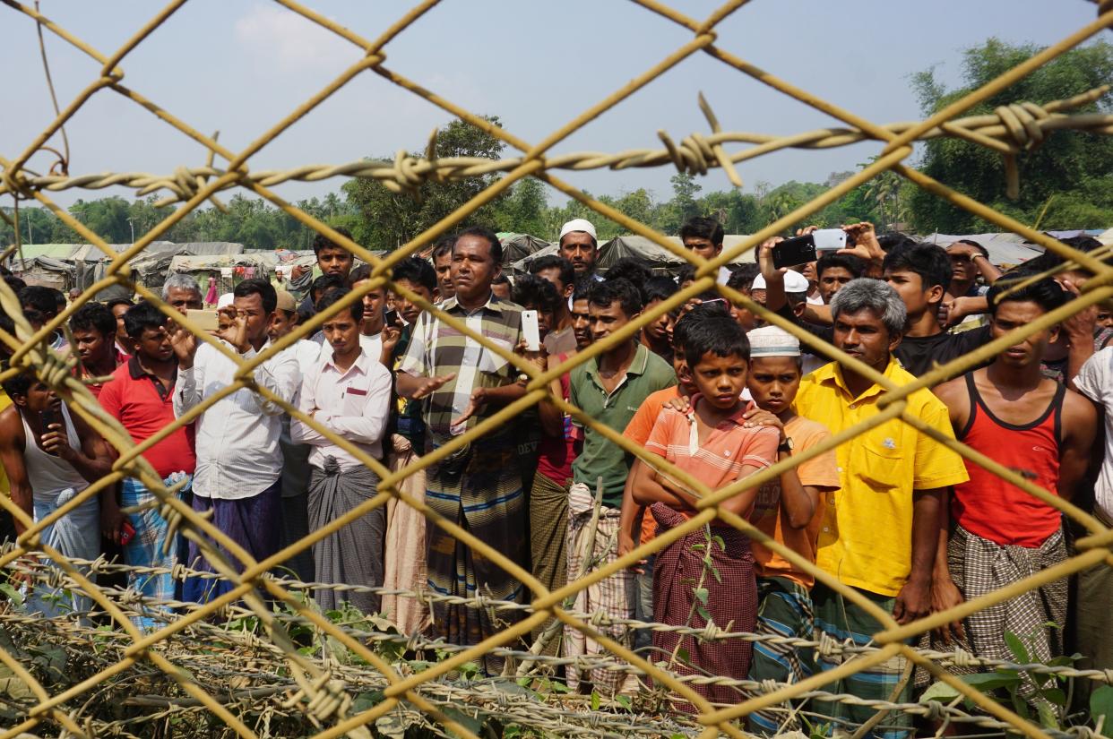 Rohingya Muslims gather behind Myanmar's border lined with barbed wire fences in Maungdaw district, located in Rakhine State bounded by Bangladesh on March 18, 2018. (Photo: JOE FREEMAN via Getty Images)