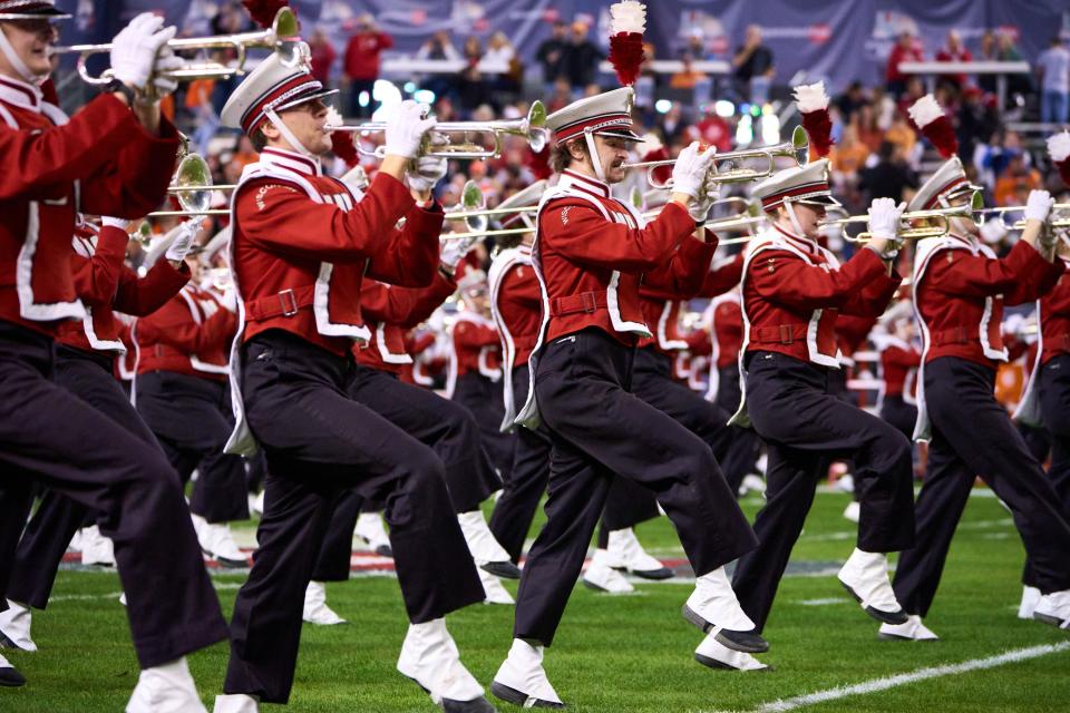The Wisconsin Badgers marching band takes the field while high-stepping before the Guaranteed Rate Bowl Game at Chase Field on Tuesday, Dec. 27, 2022. Credit: Alex Gould/The Republic-USA TODAY NETWORK