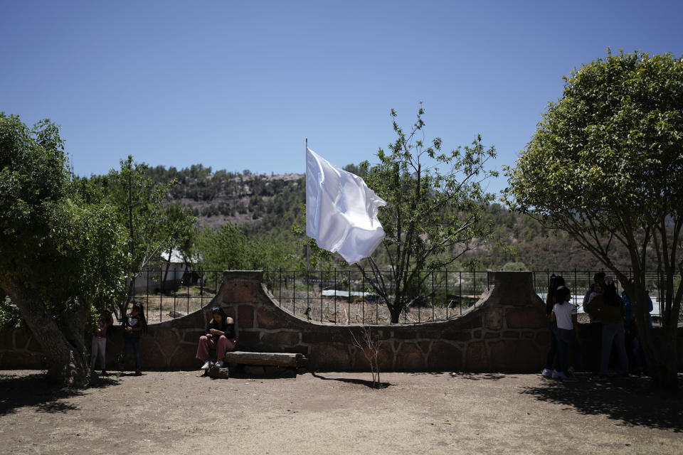 A peace flag flutters on the perimeter fence of the Saint Francis Xavier Parish church, where two Jesuit priests were murdered in 2022 by gang leader "El Chueco," in Cerocahui, Mexico, Sunday, May 12, 2024. The National Guard established a permanent base in Cerocahui in response to the killings and the military remained in the area after El Chueco was found dead in 2023. (AP Photo/Eduardo Verdugo)