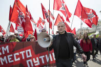 <p>Russian opposition activist Sergey Udaltsov, foreground, leads a group of his supporters during a Communist rally to mark May Day in Moscow, Russia, May 1, 2018. More than 100,000 people came out on the streets on Moscow to march in the traditional May Day parade. The banner behind him reads ‘Communism instead of Putin’. (Photo: Alexander Zemlianichenko/AP) </p>