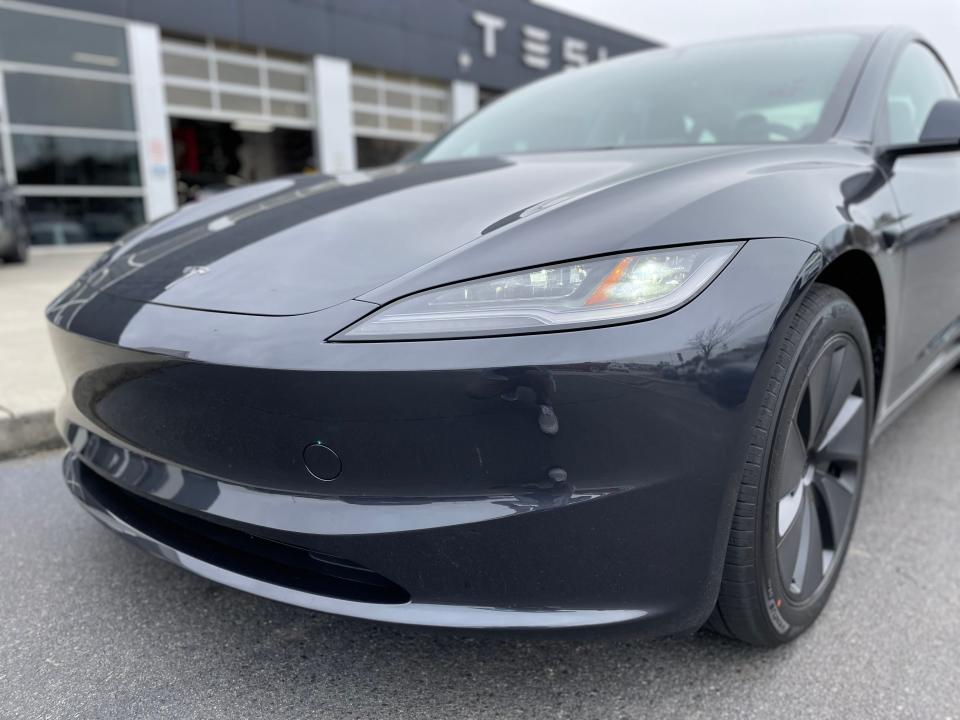 close-up of the nose of a black Tesla