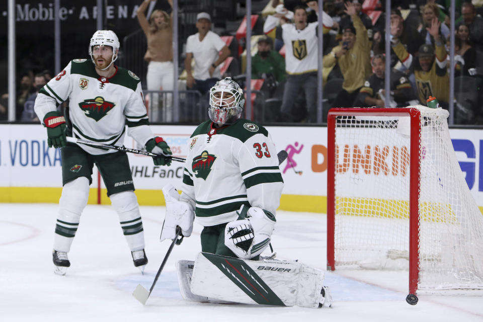 Minnesota Wild goalie Cam Talbot (33) and defenseman Ian Cole (28) react after the Vegas Golden Knights scored during the second period of Game 7 of an NHL hockey Stanley Cup first-round playoff series Friday, May 28, 2021, in Las Vegas. (AP Photo/Joe Buglewicz)