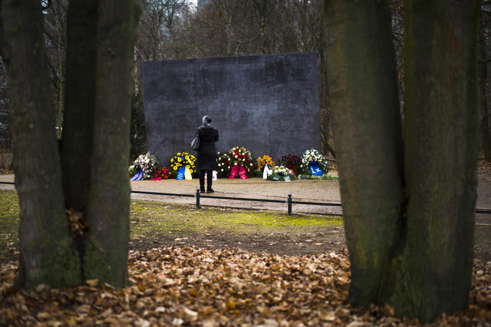 A woman stand in front of the Memorial to Homosexuals, persecuted under Nazism, in Berlin, Germany, Wednesday, Jan. 27, 2021 during the International Holocaust Remembrance Day. (AP Photo/Markus Schreiber)