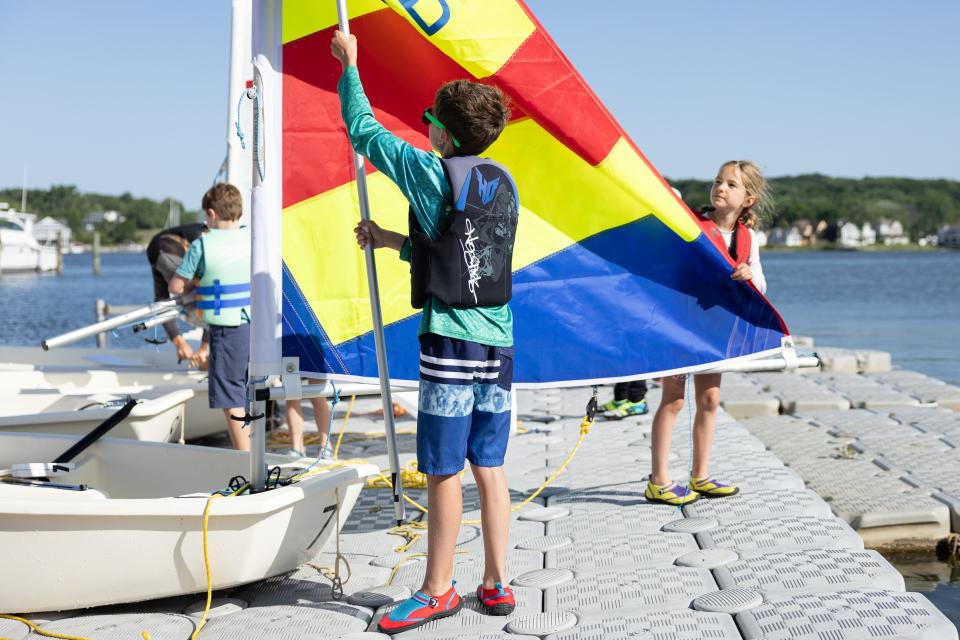 A young sailor of MBJA prepares his boat before setting sail on Lake Macatawa on June 12, 2024.