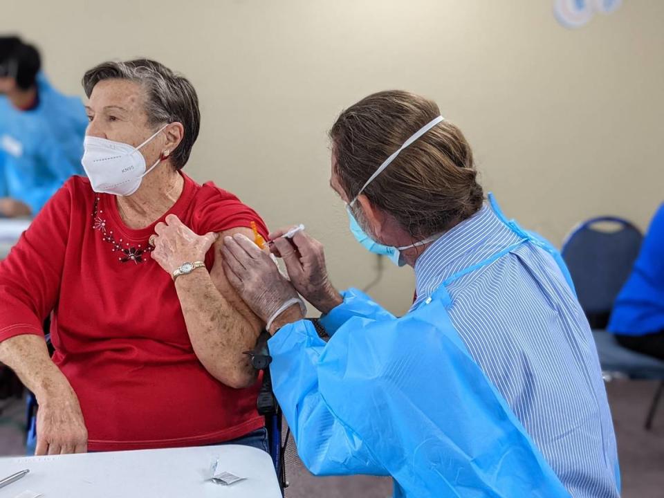 1/17/21--Joyce Coffman, an 84-year-old resident of the Woodlands Village retirement community in Bradenton, receives the first dose of a COVID-19 vaccine.