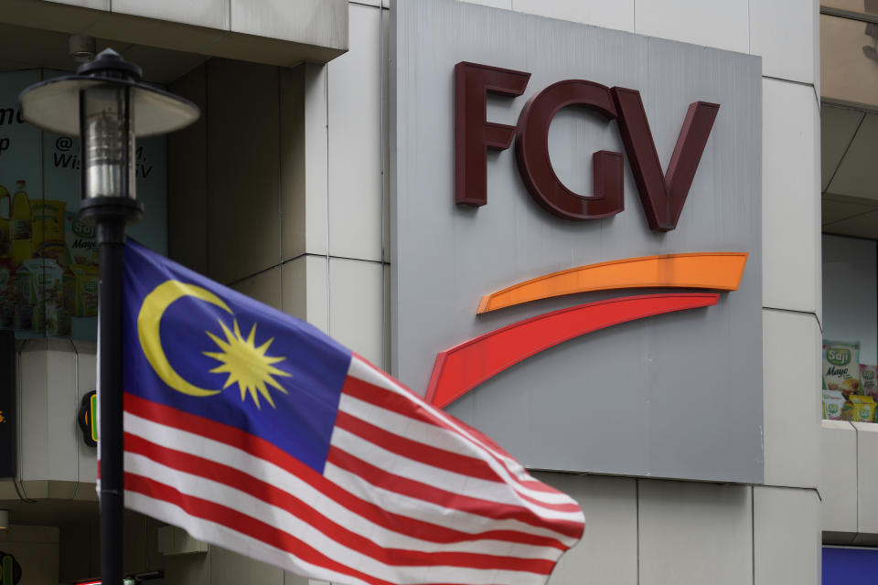 A Malaysian national flag is on display outside FGV Holdings Berhad, one of Malaysia's largest palm oil companies, in Kuala Lumpur, Thursday, Oct. 1, 2020. Malaysian palm oil producer FGV Holdings Berhad vowed Thursday to “clear its name” after the U.S. banned imports of its palm oil over allegations of forced labor and other abuses. (AP Photo/Vincent Thian)
