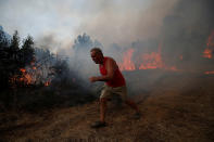 <p>A villager works to put out a forest fire in the village of Brejo Grande, near Castelo Branco, Portugal, July 25, 2017. (Rafael Marchante/Reuters) </p>