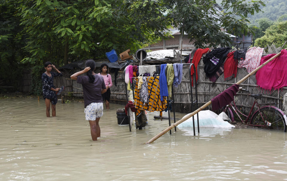 Villagers hangs their clothes to dry in Panikhaiti village, in Kamrup District, Assam, India on Tuesday, on July 14, 2020. Villages in Assam were flooded due to heavy rains. The rising water level inundated houses, residents were forced to move to a safer place. (Photo by Hafiz Ahmed/Anadolu Agency via Getty Images)