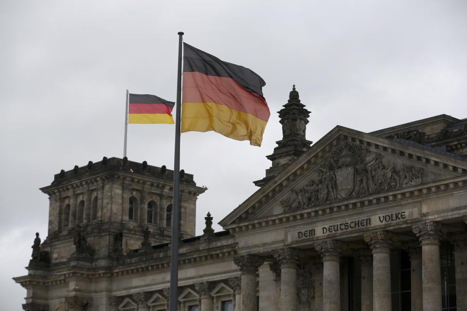 German flags flutter in the wind on the Reichstag building in Berlin, September 23, 2013. Angela Merkel won a landslide personal victory in Germany's general election on Sunday, but her conservatives appeared just short of the votes needed to rule on their own and may have to convince leftist rivals to join a coalition government. (REUTERS/Wolfgang Rattay)