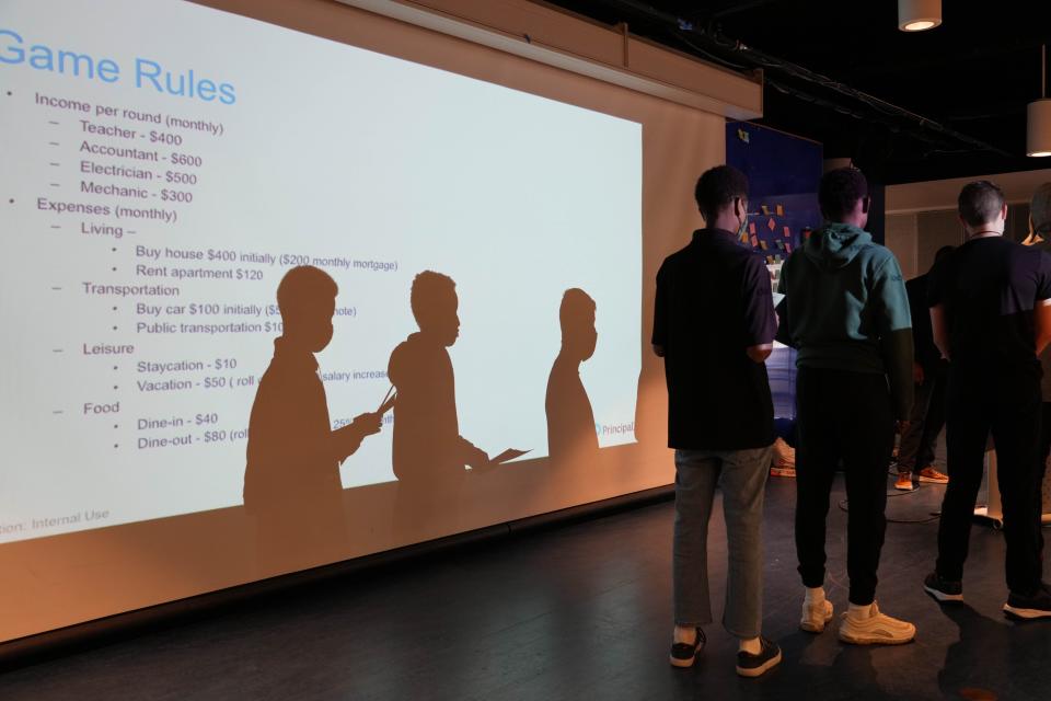 Students wait in line to present their financial plan for a game at one of the breakout sessions at the Hip-Hope, Inc.’s “A Greater Des Moines Conference for Young Men of Color” on Saturday, Oct. 22, 2022 at Drake University Olmsted Center.