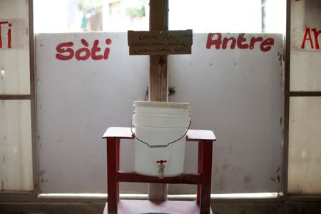 A bucket filled with water mixed with chlorine for visitors to wash their hands is seen at the entrance of the Cholera Treatment Center of Diquini in Port-au-Prince, Haiti, September 7, 2016. REUTERS/Andres Martinez Casares