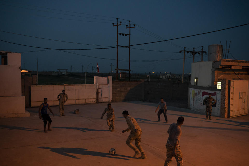 In this April 9, 2019 photo, Iraqi army 20th division soldiers play soccer in a military base in Badoush, Iraq. (AP Photo/Felipe Dana)