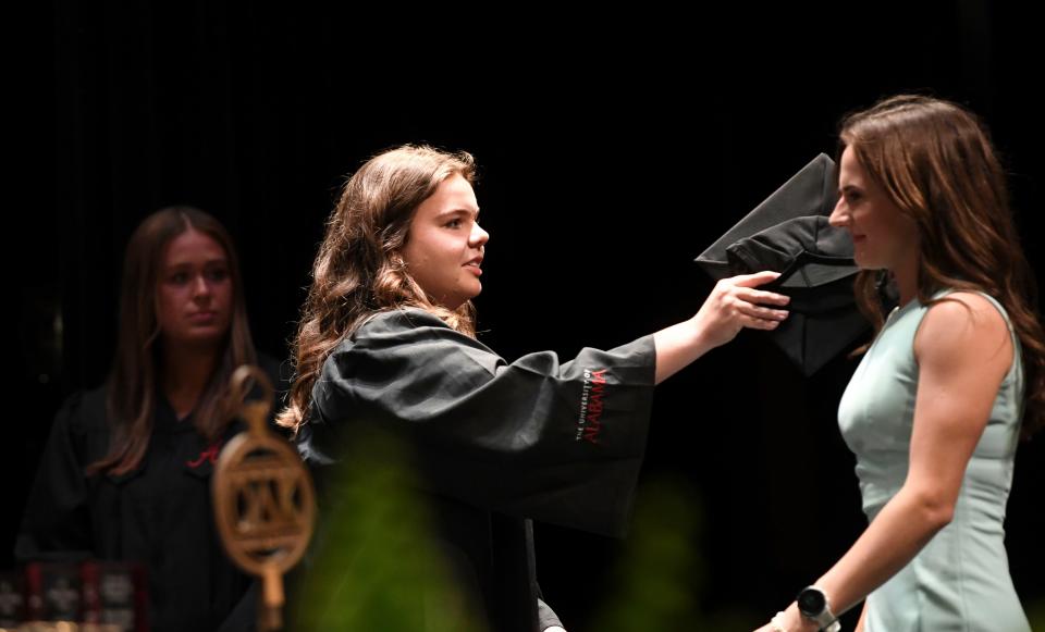 New members of the Mortar Board Honor Society are tapped during the Tapping on the Mound academic awards ceremony held Friday in the English Building because of the threat of inclement weather at the University of Alabama.