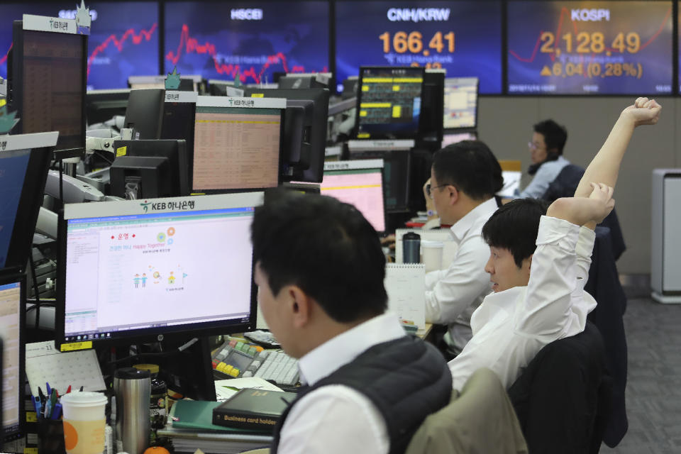 A currency trader stretches at the foreign exchange dealing room of the KEB Hana Bank headquarters in Seoul, South Korea, Thursday, Nov. 14, 2019. Asian stock markets were mixed Thursday amid doubts about the status of a U.S.-Chinese trade deal after the U.S. Federal Reserve’s chairman said it is likely to leave its benchmark interest rate unchanged. (AP Photo/Ahn Young-joon)