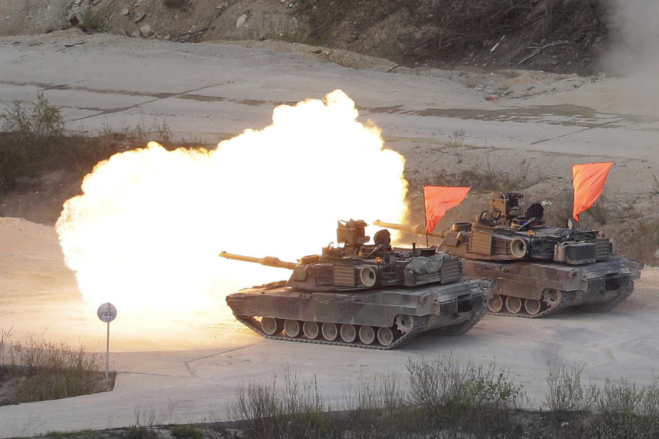 FILE - In this April 26, 2017, file photo, U.S. Army's M1 A2 tanks fire during South Korea-U.S. joint military live-fire drills at Seungjin Fire Training Field in Pocheon, South Korea, near the border with North Korea. The South Korean and U.S. militaries have postponed on Thursday, Feb. 27, 2020, their annual joint drills out of concerns over a virus outbreak. (AP Photo/Ahn Young-joon, File)