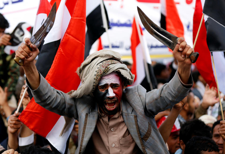 Man waves traditional daggers in Sanaa, Yemen