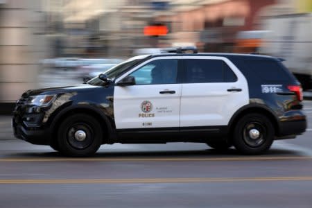 A Los Angeles Police Department cruiser with lights and sirens going speeds down on a city street in Los Angeles, California, U.S. August 10, 2017. REUTERS/Mike Blake