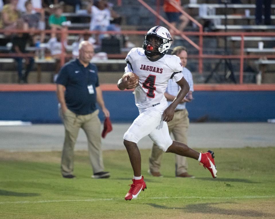 Marquez Jones (4) takes it in for a touchdown to tie the score at 6-6 during the West Florida vs Escambia football game at Escambia High School in Pensacola on Thursday, Aug. 24, 2023.