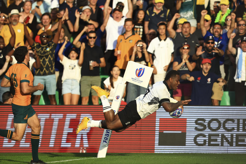 Fiji's Josua Tuisova scores a try during the Rugby World Cup Pool C match between Australia and Fiji at the Stade Geoffroy Guichard in Saint-Etienne, France, Sunday, Sept. 17, 2023. (AP Photo/Aurelien Morissard)