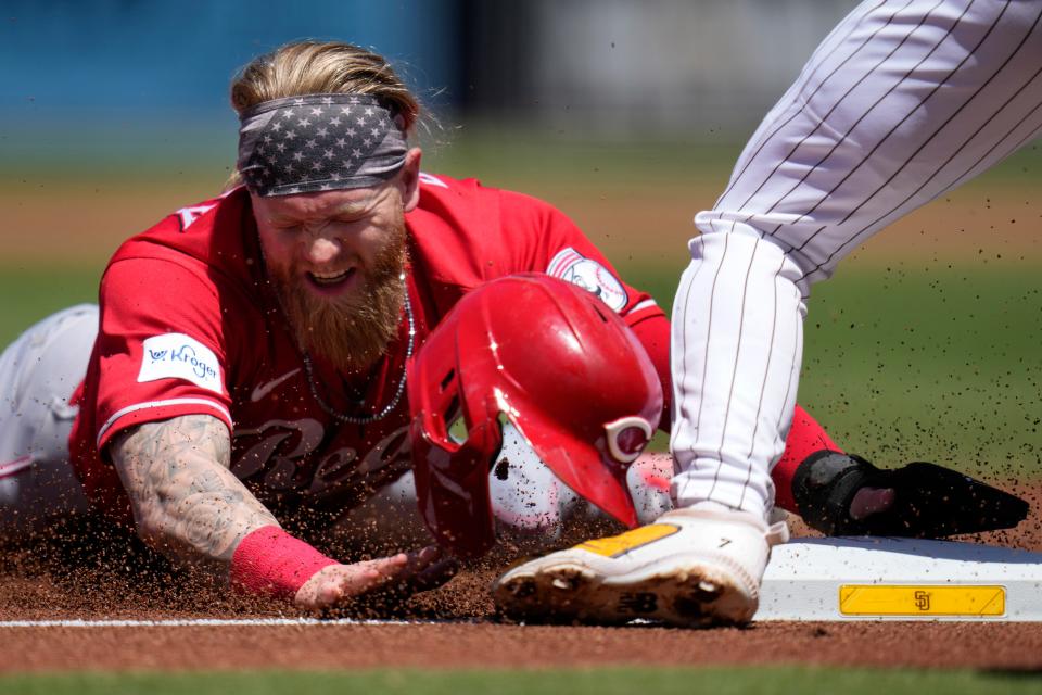 Cincinnati Reds' Jake Fraley slides into third base, advancing from first off a groundout by Nick Senzel during the first inning of a baseball game against the San Diego Padres, Wednesday, May 3, 2023, in San Diego.