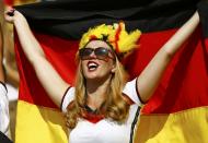 A German fan cheers with her country's national flag before the start of the 2014 World Cup quarter-finals between France and Germany at the Maracana stadium in Rio de Janeiro July 4, 2014. REUTERS/Kai Pfaffenbach
