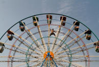 <p>A man balances himself on a Ferris wheel as he inspects it at a public park in Sardaryab, Charsadda, on the outskirts of Peshawar, Pakistan, Aug. 25, 2016. (Photo: Fayaz Aziz/Reuters)</p>