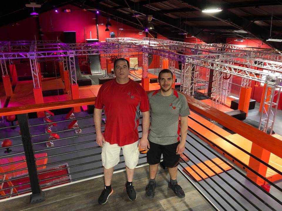 Alan (left) and Anthony Jordan stand on the spacious mezzanine level overlooking the 17,000-square-foot gym that they have brought to Exeter.