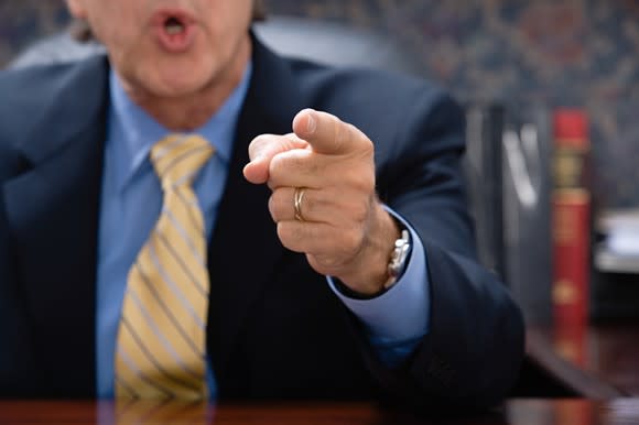 An angry-looking man points a finger