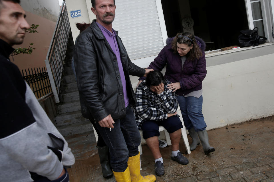 <p>Maria Kriada is comforted outside her destroyed house following flash floods which hit areas west of Athens on November 15 killing at least 15 people, in Nea Peramos, Greece, Nov. 16, 2017. (Photo: Alkis Konstantinidis/Reuters) </p>