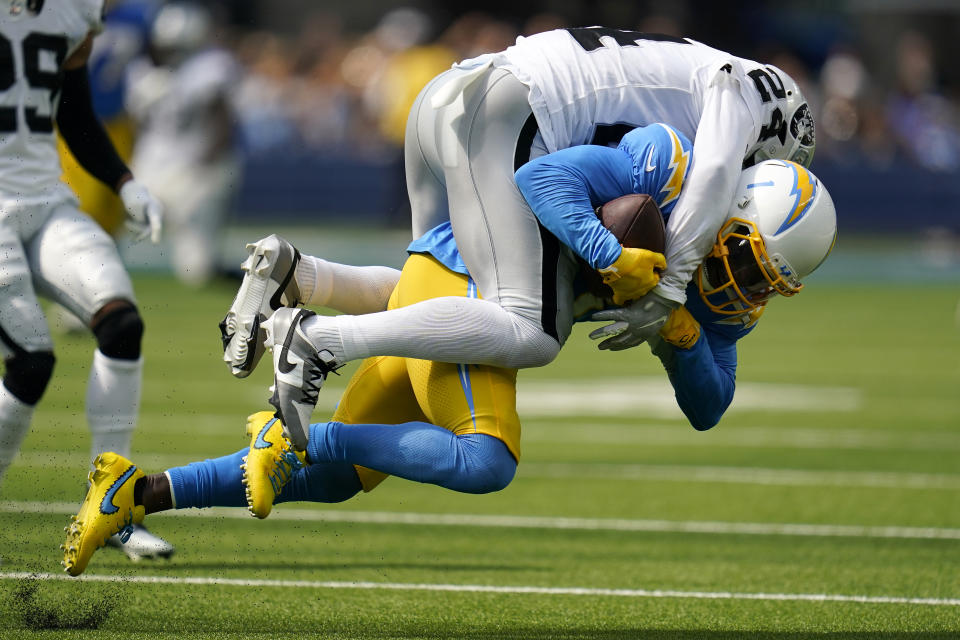 Los Angeles Chargers wide receiver DeAndre Carter, bottom, is tackled by Las Vegas Raiders safety Johnathan Abram during the first half of an NFL football game in Inglewood, Calif., Sunday, Sept. 11, 2022. (AP Photo/Gregory Bull)