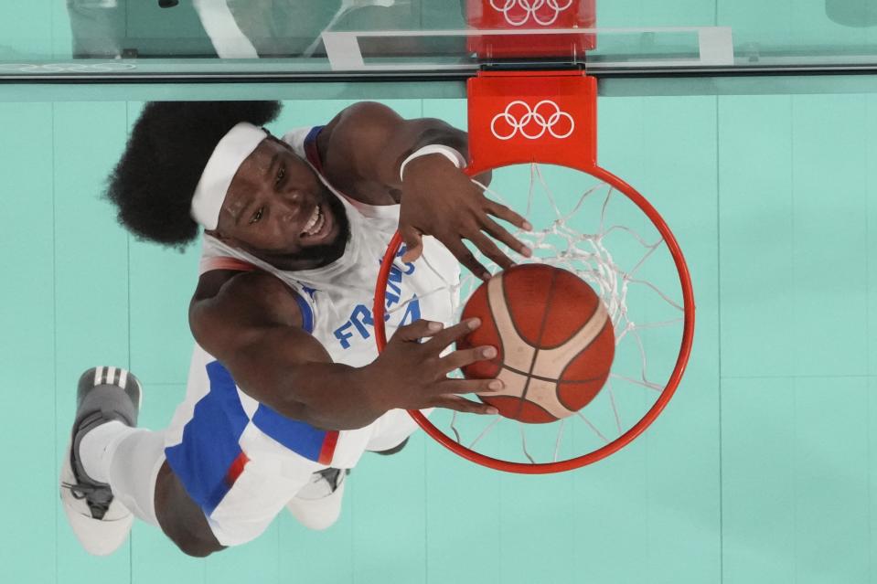 Guerschon Yabusele (7), of France dunks during a men's gold medal basketball game at Bercy Arena at the 2024 Summer Olympics, Saturday, Aug. 10, 2024, in Paris, France. (Evelyn Hockstein/Pool Photo via AP)