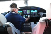 Ed Hillis, a contract pilot for Bombardier, sits in the cockpit of a mockup of Bombardier’s Learjet Liberty at the National Business Aviation Association (NBAA) exhibition in Las Vegas