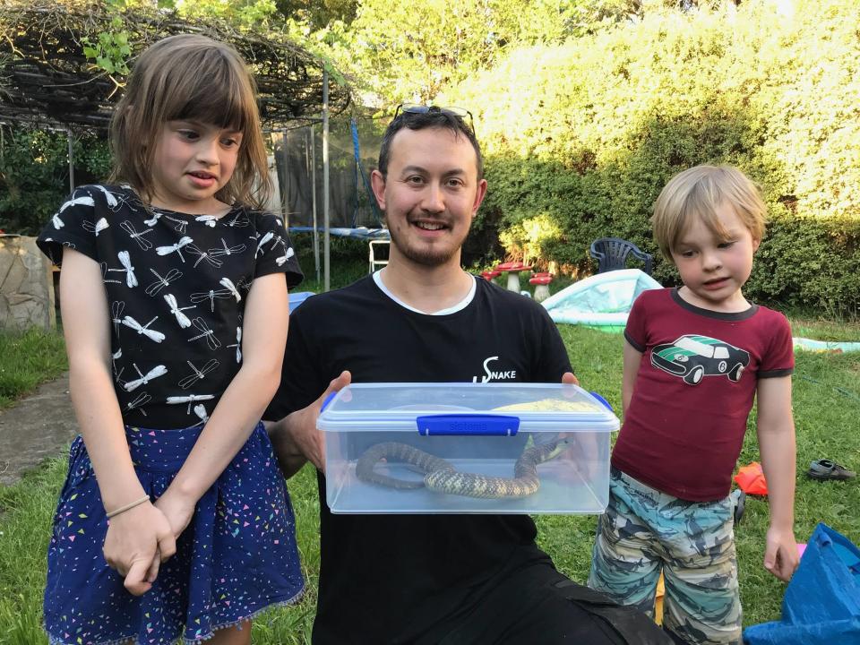 Mr Pelley with the eastern tiger snake and the two children of the Preston dad. Source: Dave Hall