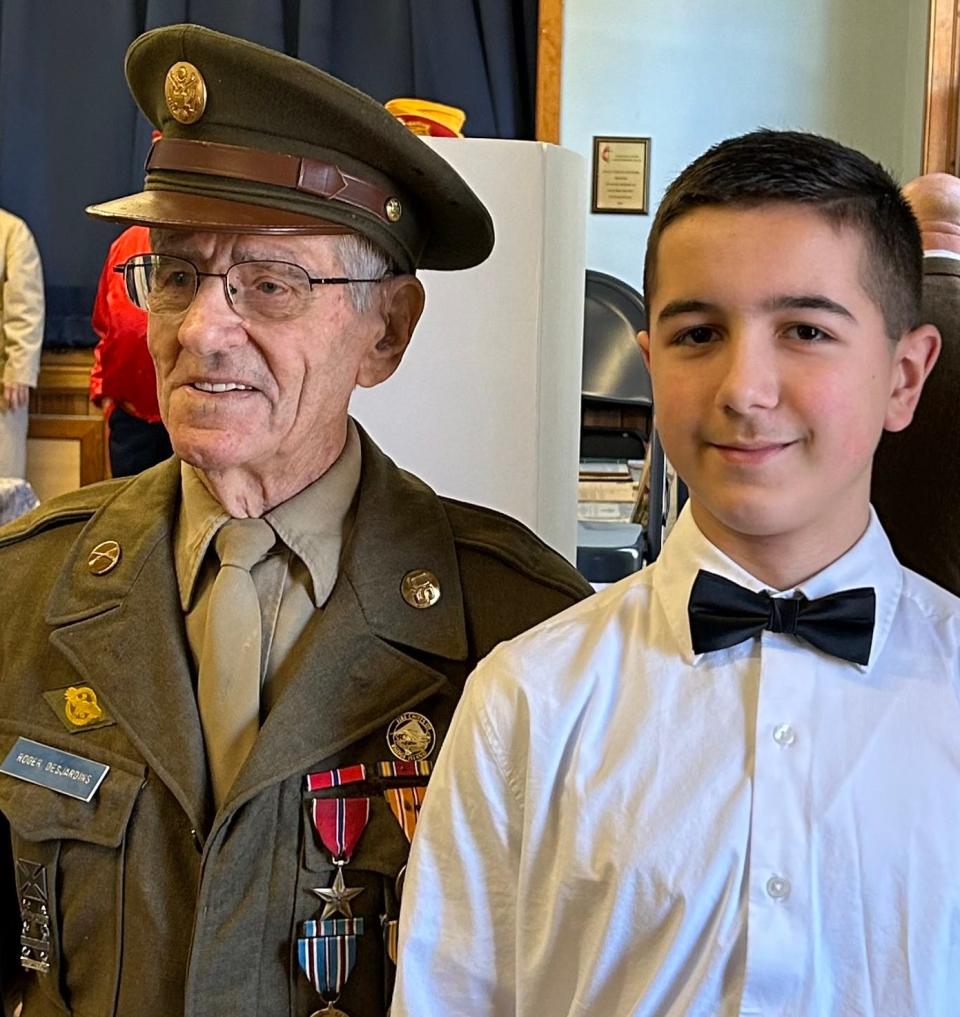 Roger Desjardins of North Providence, a 99-year-old WWII veteran, stands with Chase Warish, a great-grandson of Sgt. Michael Warish. Sergeant Warish survived the 1943 torpedoing of the troopship Dorchester in which the Four Chaplains lost their lives.