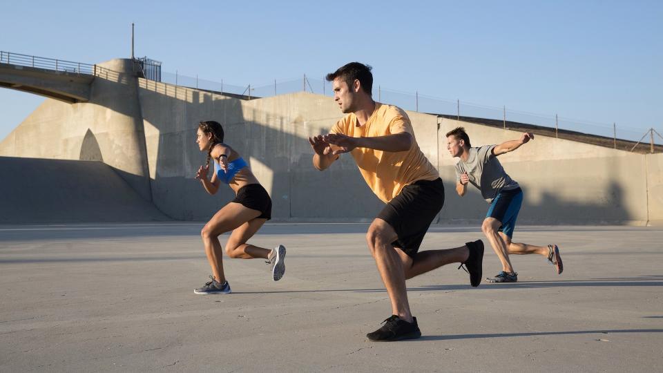 Three people doing speed skaters