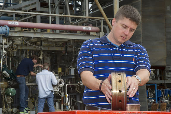 Propulsion systems engineer Greg Barnett prepares a rocket injector for a hot fire test at NASA's Marshall Space Flight Center.