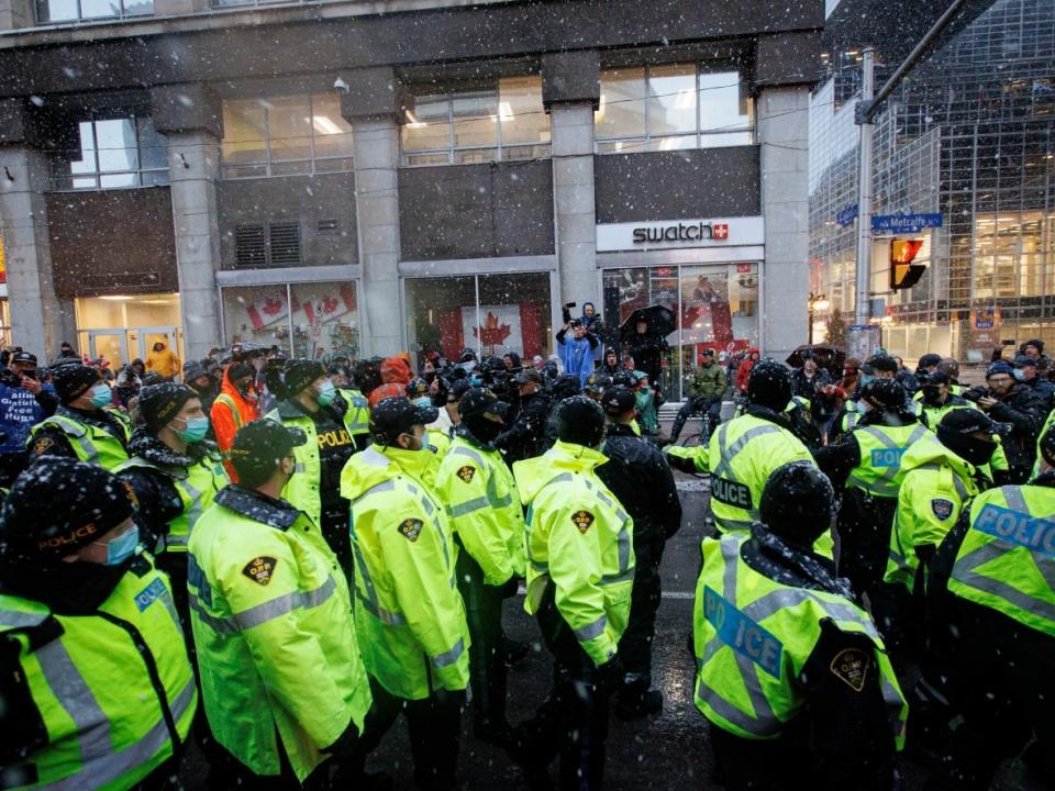 Police leave the scene after making an arrest at the encampment near Parliament Hill, in Ottawa, on Feb. 17, 2022. (Evan Mitsui/CBC - image credit)