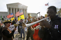 Jonathan Neal, a senior at Howard University, plays his trumpet in support of health care reform in front of the Supreme Court.