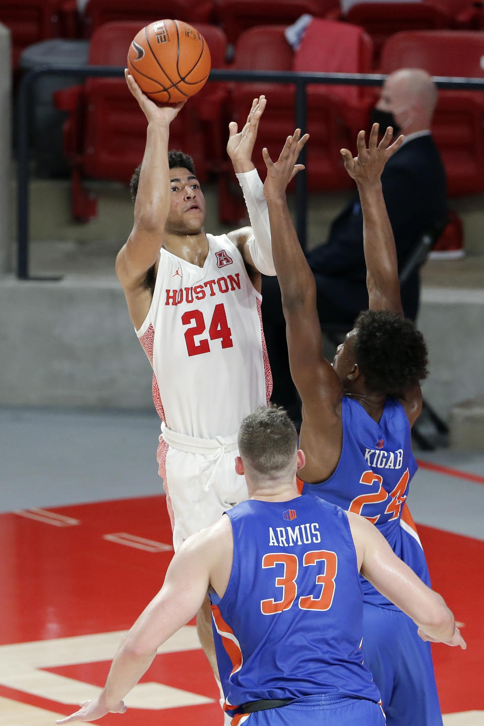 Houston guard Quentin Grimes (24) puts up a shot over Boise State forward Abu Kigab (24) and forward Mladen Armus (33) during the first half of an NCAA college basketball game Friday, Nov. 27, 2020, in Houston. (AP Photo/Michael Wyke)